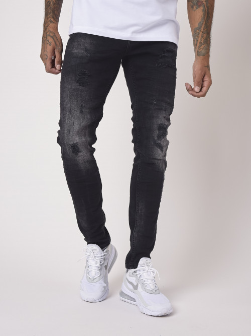 Jeans pitillo efecto desteñido y desgastado con agujeros negros