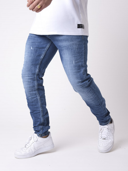 Scratch-worn blue wash skinny jeans