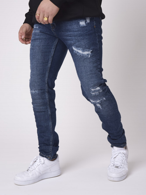 Jeans slim azul crudo con efecto arenado y rasgado - Azul