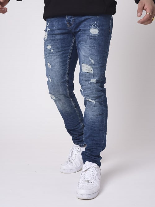 Jeans skinny blu effetto consumato con macchie di vernice