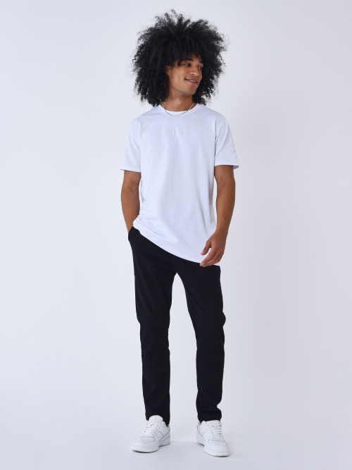 Man in white crew neck t-shirt and black and white pants standing on  sidewalk during photo – Free Style Image on Unsplash