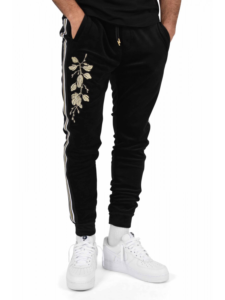 Velvet jogging pants with contrasting stripes and gold floral patch